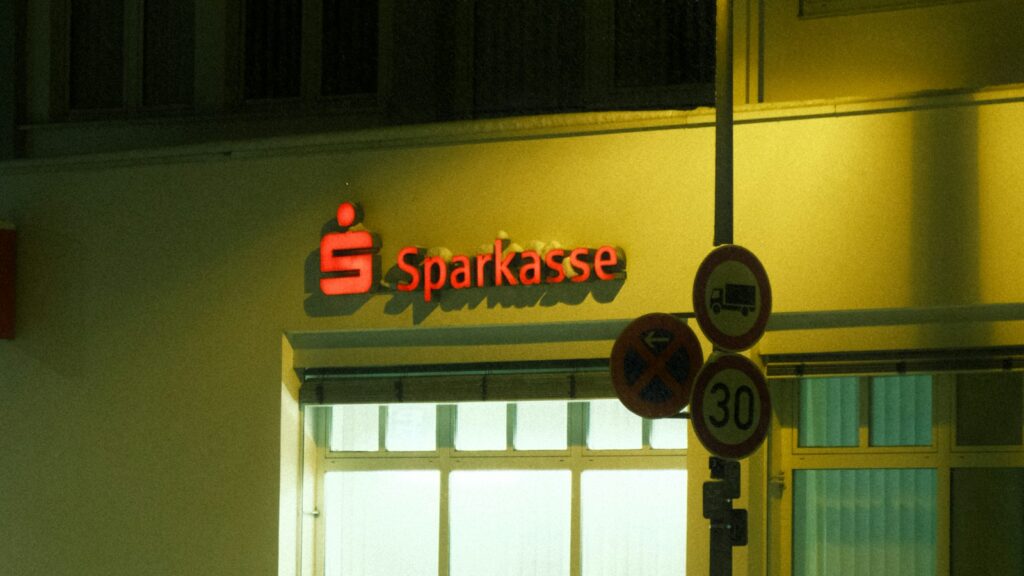 The illuminated sign of a Sparkasse bank branch in Germany at night