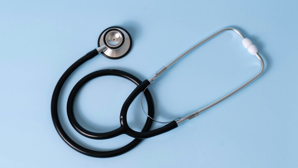 A stethoscope on a light blue background