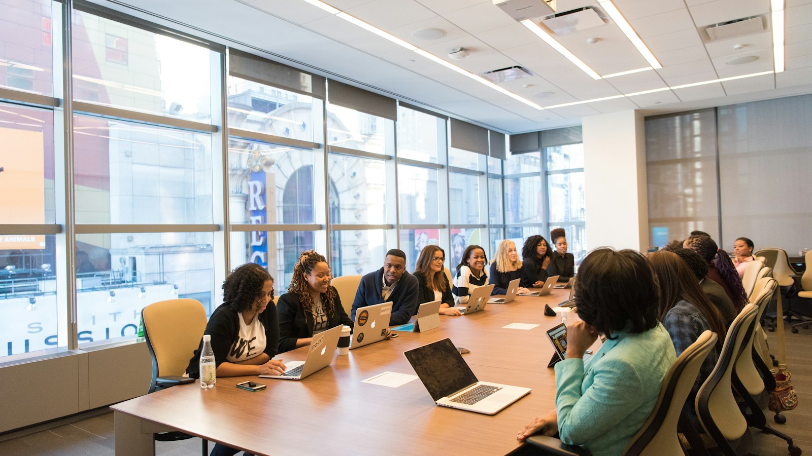 Colleagues working with laptops around a shared table